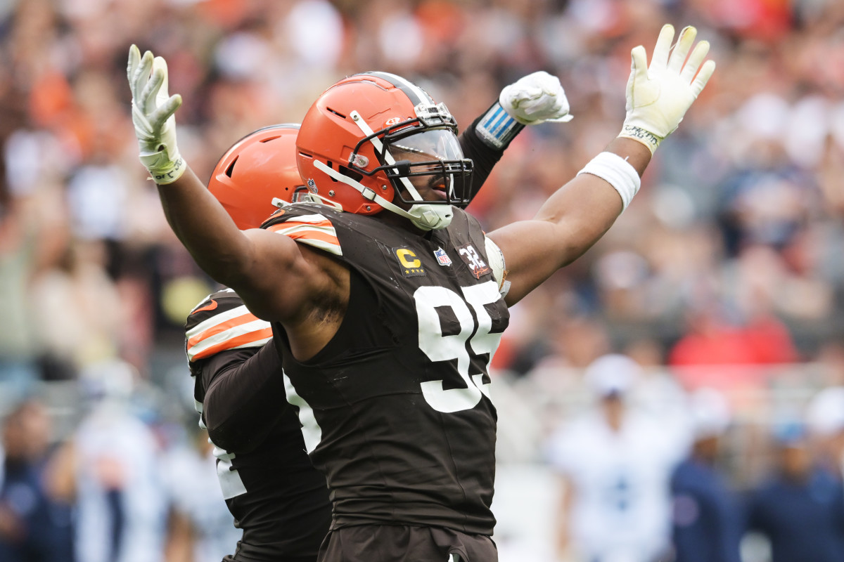 Myles Garrett stands with his hands out to either side in celebration