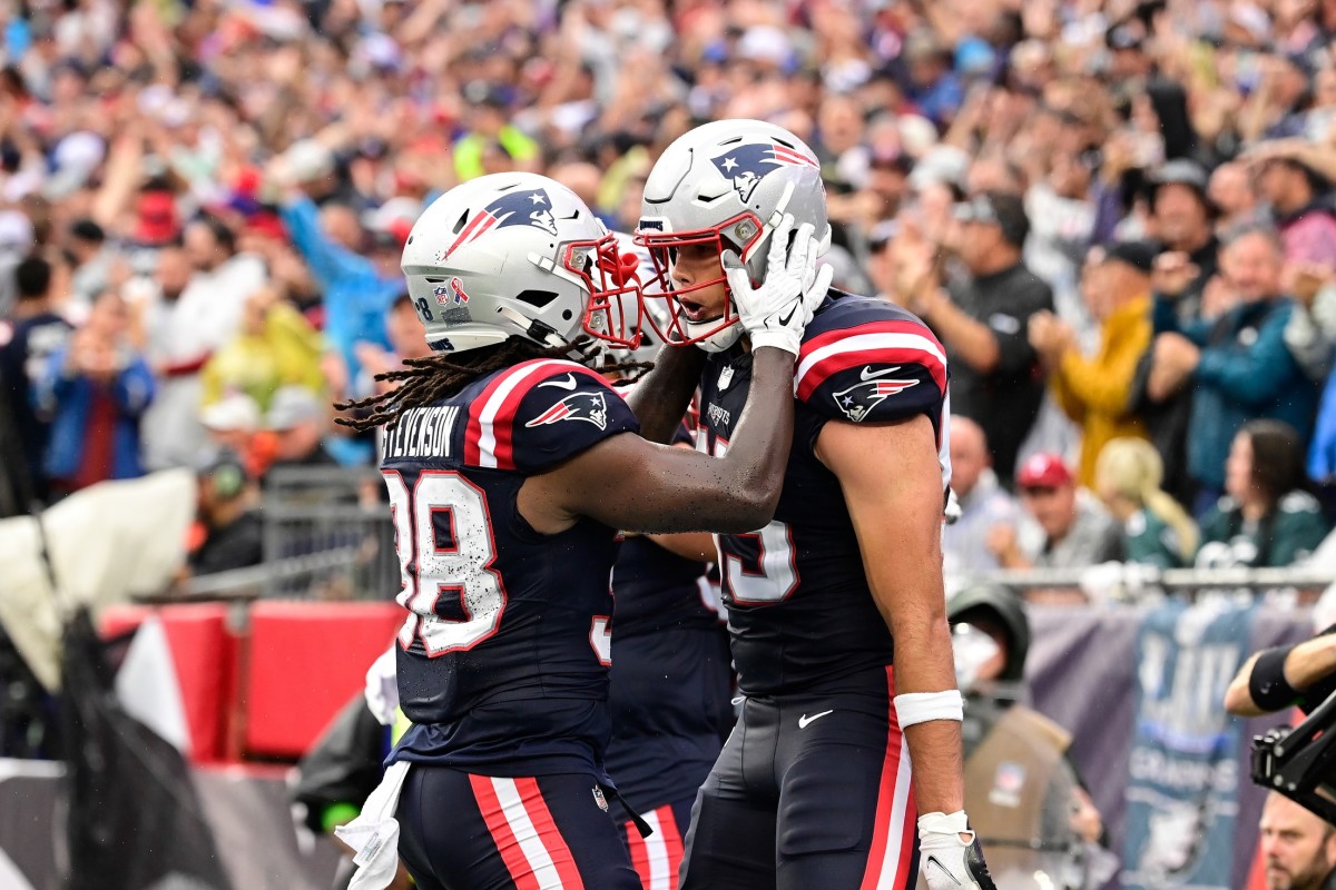 Sep 10, 2023; Foxborough, Massachusetts, USA; New England Patriots tight end Hunter Henry (right) celebrates a touchdown with running back Rhamondre Stevenson (38) during the first half against the Philadelphia Eagles at Gillette Stadium. Mandatory Credit: Eric Canha-USA TODAY Sports  