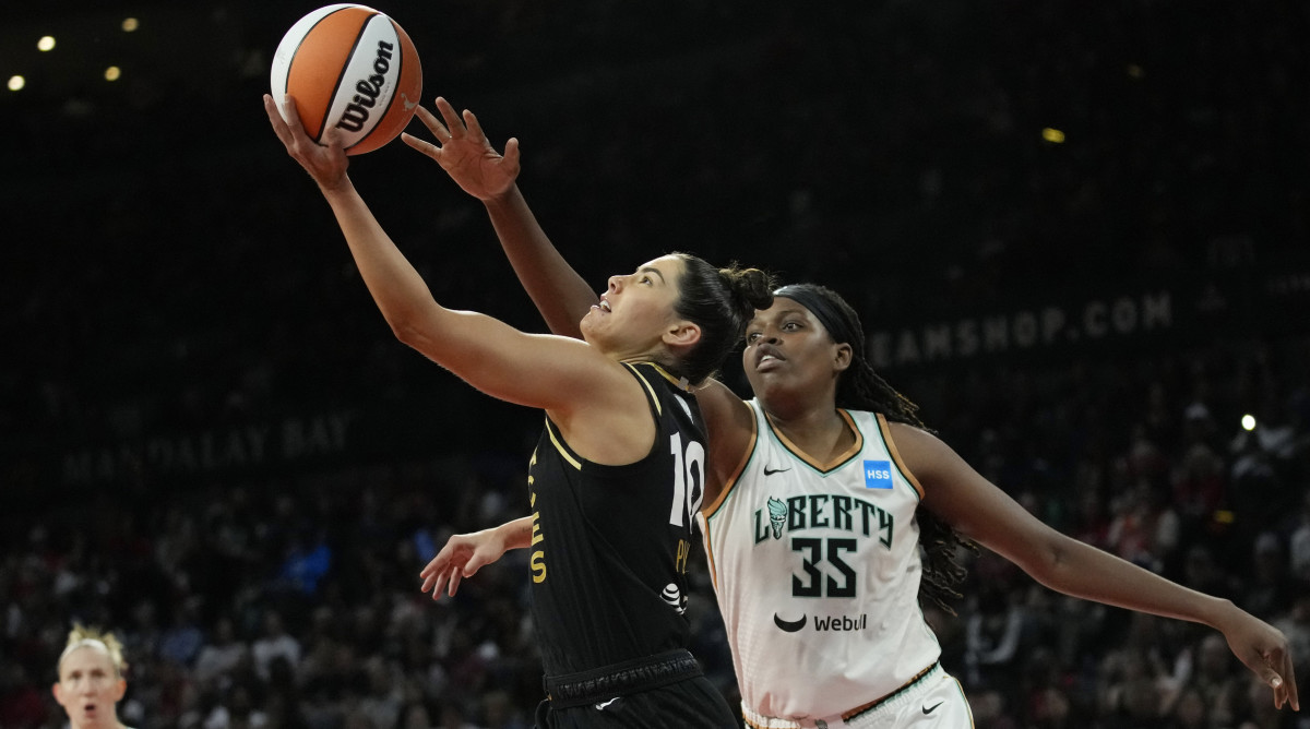 Las Vegas Aces guard Kelsey Plum shoots around New York Liberty forward Jonquel Jones (35) during the WNBA Finals.