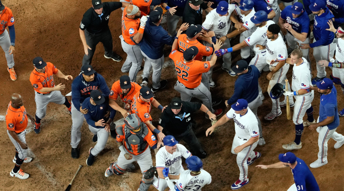 Players from Houston Astros and Texas Rangers clear the benches after Texas Rangers' Adolis Garcia was hit by a pitch thrown by Houston Astros relief pitcher Bryan Abreu during the eighth inning in Game 5 of the baseball American League Championship Series Friday, Oct. 20, 2023, in Arlington, Texas. (AP Photo/Godofredo A. Vásquez)   