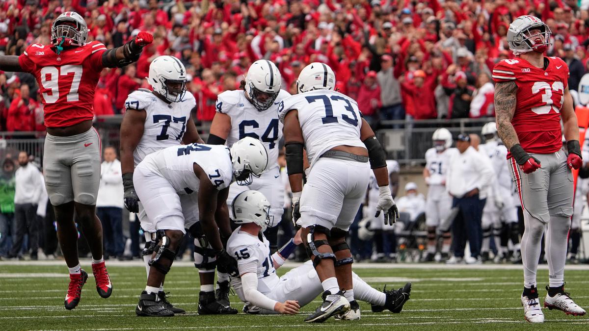 Ohio State Buckeyes defensive ends Kenyatta Jackson Jr. Jack Sawyer celebrate a sack
