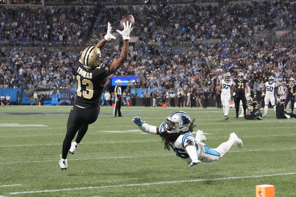 Sep 18, 2023; New Orleans Saints receiver Michael Thomas (13) catches a pass as Carolina Panthers cornerback Donte Jackson (26) defends. Mandatory Credit: Bob Donnan-USA TODAY