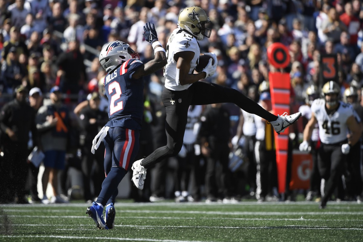 Oct 8, 2023; New Orleans Saints receiver Michael Thomas (13) makes a catch while New England Patriots cornerback Jalen Mills (2) defends. Mandatory Credit: Bob DeChiara-USA TODAY Sports