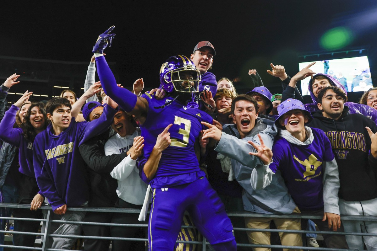 Mishael Powell celebrates with Husky fans after the 15-7 victory over ASU.