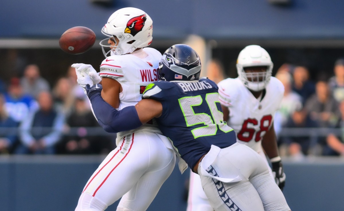 Seattle Seahawks linebacker Jordyn Brooks (56) breaks up a pass to Arizona Cardinals wide receiver Michael Wilson (14) during the second half at Lumen Field.