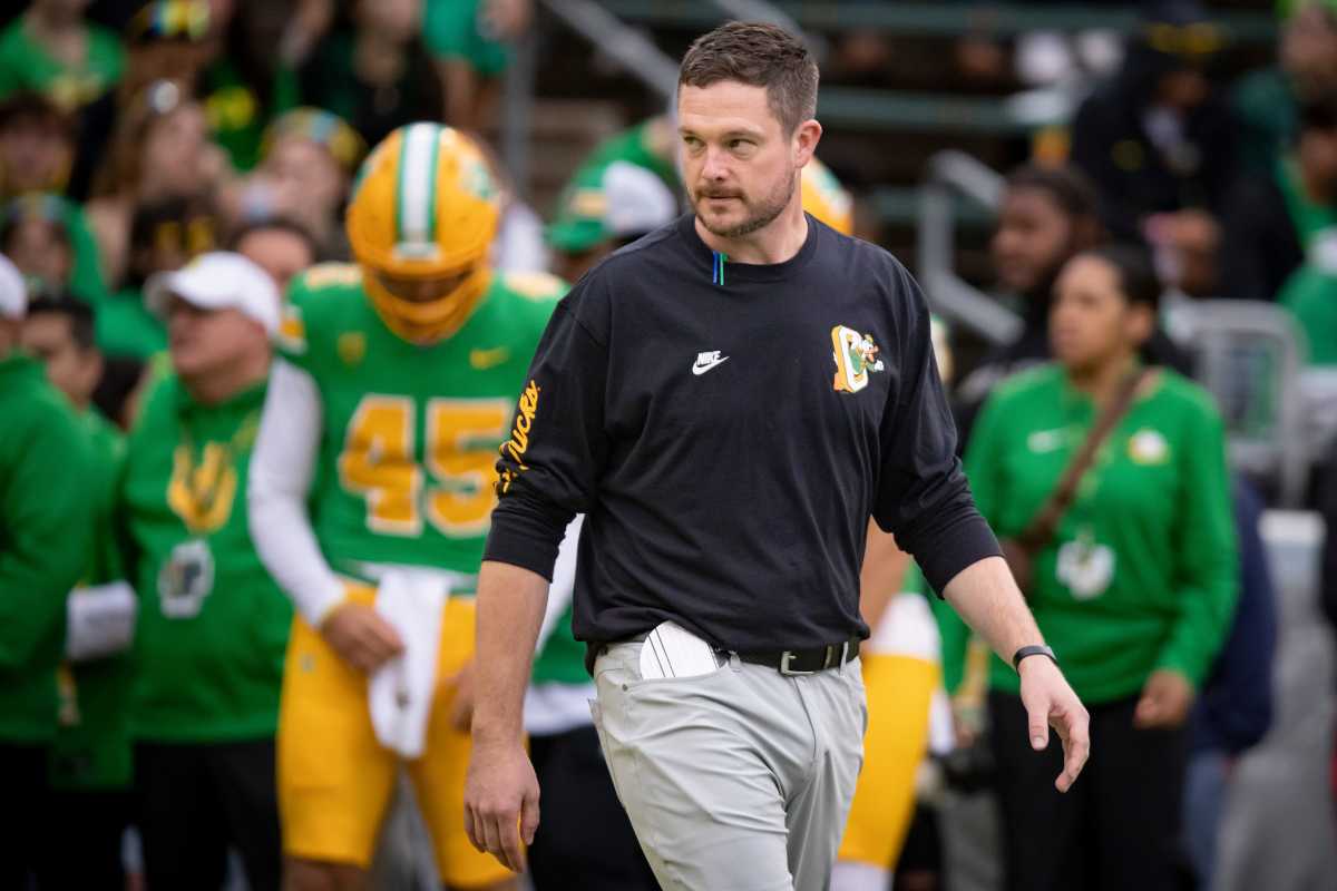 Dan Lanning walks on the field