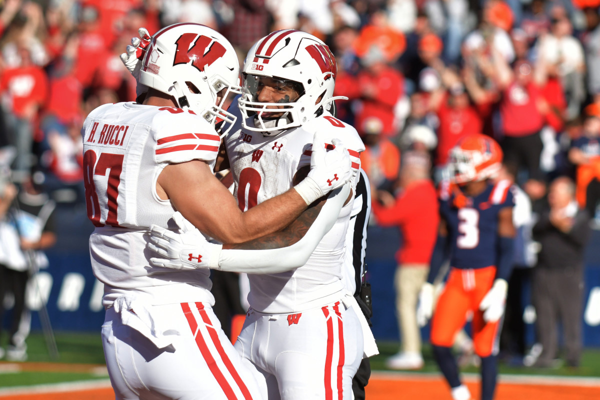 Oct 21, 2023; Champaign, Illinois, USA; Wisconsin Badgers running back Braelon Allen (0) celebrates with teammate Hayden Rucci (87) after scoring a touchdown against the Illinois Fighting Illini during the first half at Memorial Stadium. Mandatory Credit: Ron Johnson-USA TODAY Sports