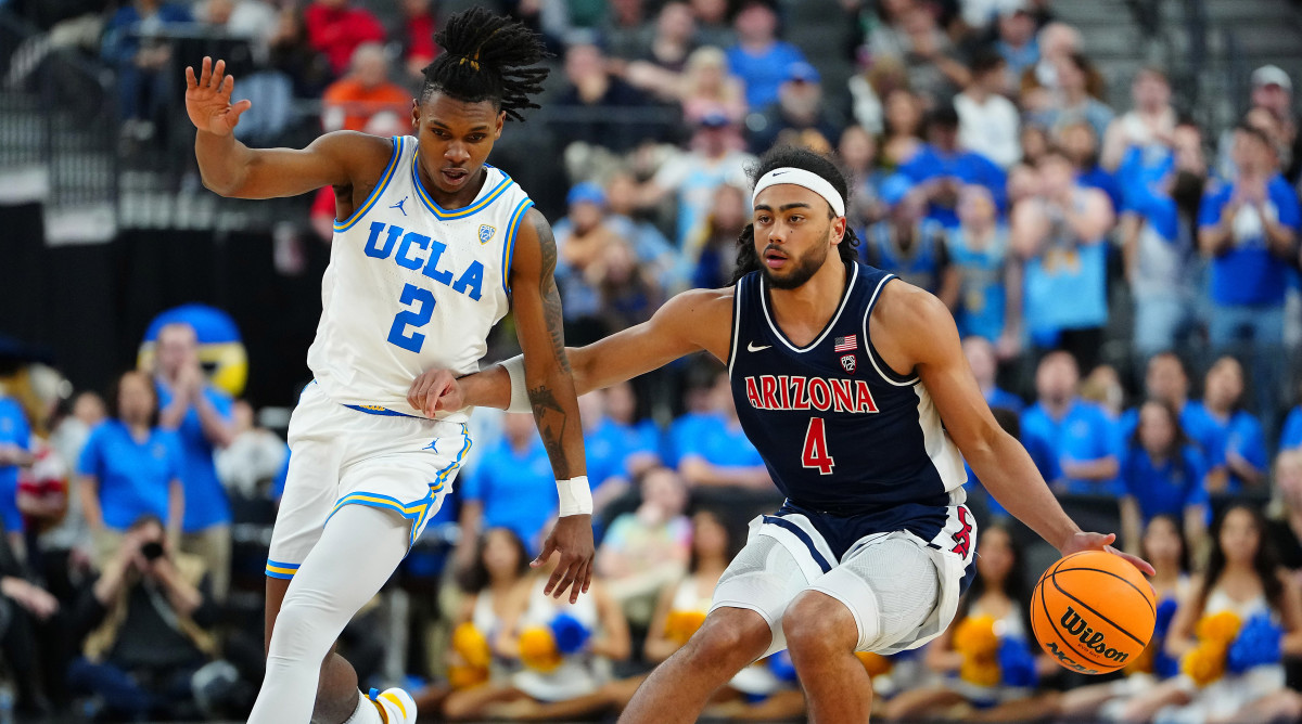 Arizona Wildcats guard Kylan Boswell dribbles against UCLA Bruins guard Dylan Andrews.