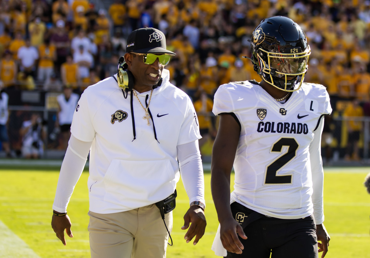 Colorado Buffaloes head coach Deion Sanders with son and quarterback Shedeur Sanders (2) against the Arizona State Sun Devils at Mountain America Stadium