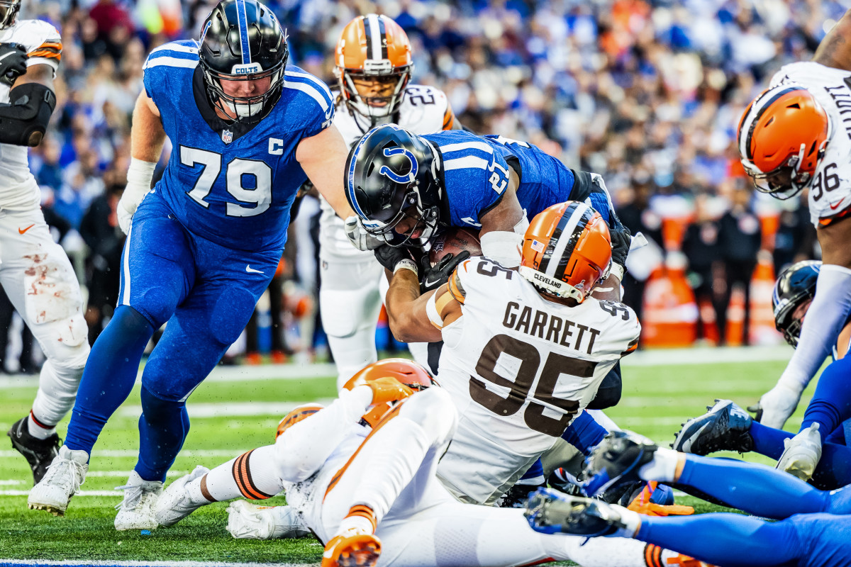 Indianapolis Colts running back Zack Moss (21) runs the ball while Cleveland Browns defensive end Myles Garrett tackles him