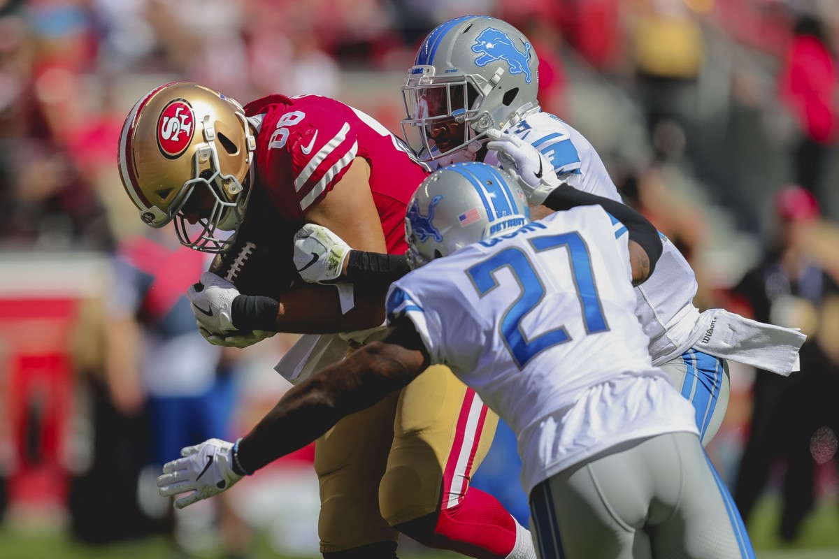 49ers tight end Garrett Celek drags a couple of Lions defenders into the end zone in Week 2 of the 2018 NFL season.