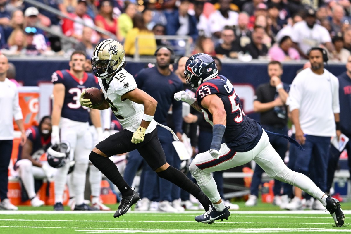 Oct 15, 2023; New Orleans Saints wide receiver Chris Olave (12) after a catch as Houston Texans linebacker Blake Cashman (53) pursues. Mandatory Credit: Maria Lysaker-USA TODAY Sports