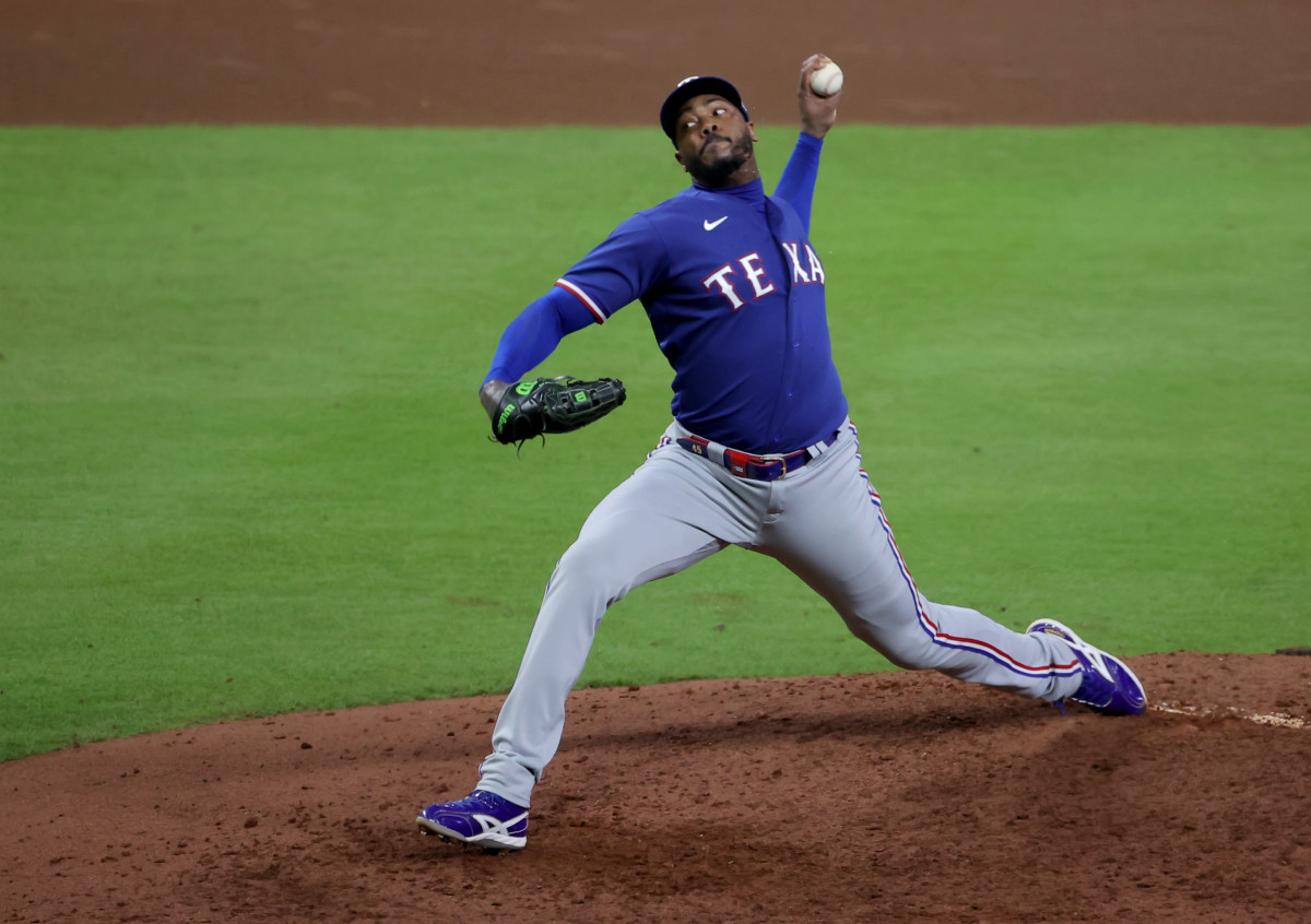 Texas Rangers pitcher Aroldis Chapman throws a pitch during the seventh inning of Game 7 of the ALCS against the Houston Astros at Minute Maid Park.