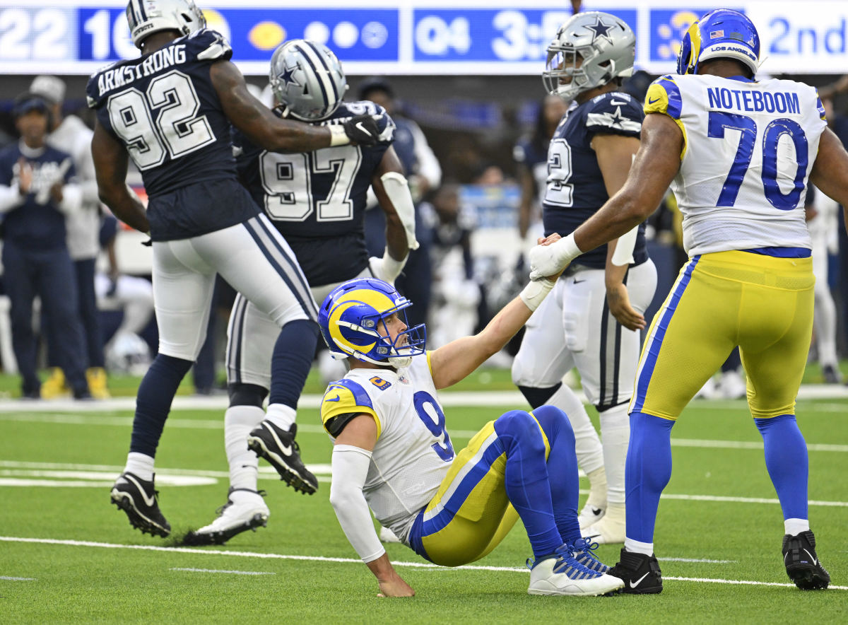 Oct 9, 2022; Inglewood, California, USA; Los Angeles Rams quarterback Matthew Stafford (9) is helped up by teammate tackle Joe Noteboom (70) after being sacked by Dallas Cowboys defensive tackle Osa Odighizuwa (97) during the fourth quarter at SoFi Stadium.  