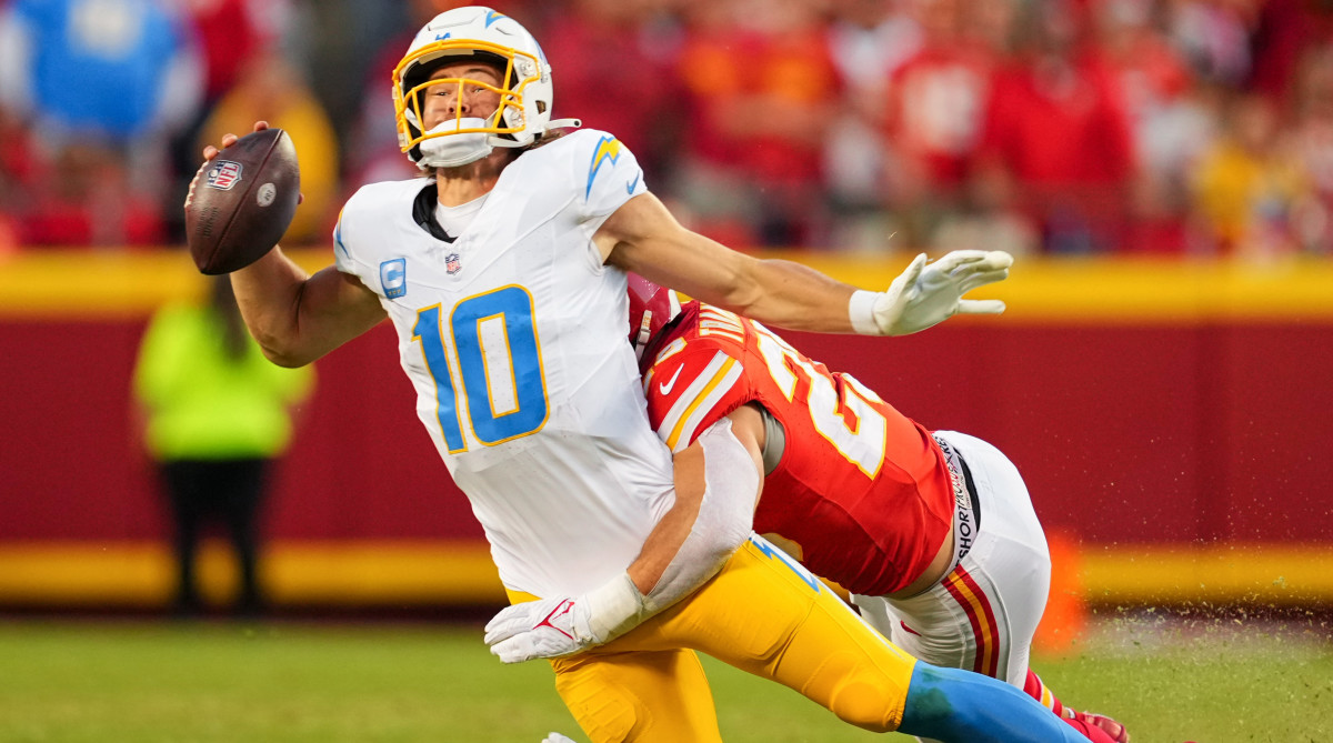 Chargers QB Justin Herbert is tackled by a Chiefs player