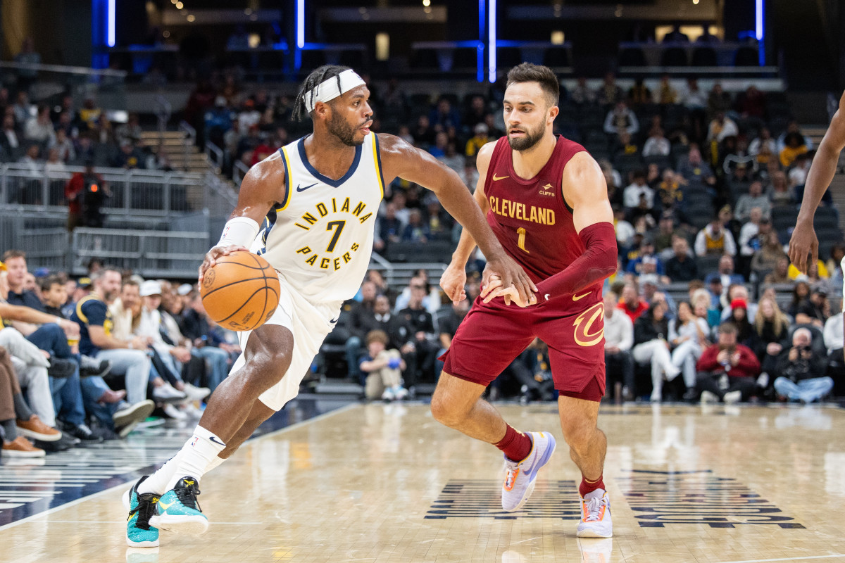 Oct 20, 2023; Indianapolis, Indiana, USA; Indiana Pacers guard Buddy Hield (7) dribbles the ball while Cleveland Cavaliers guard Max Strus (1) defends in the second half at Gainbridge Fieldhouse.