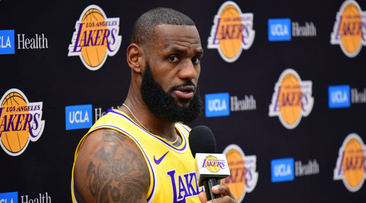 Los Angeles Lakers star LeBron James speaks into a microphone at a team event.