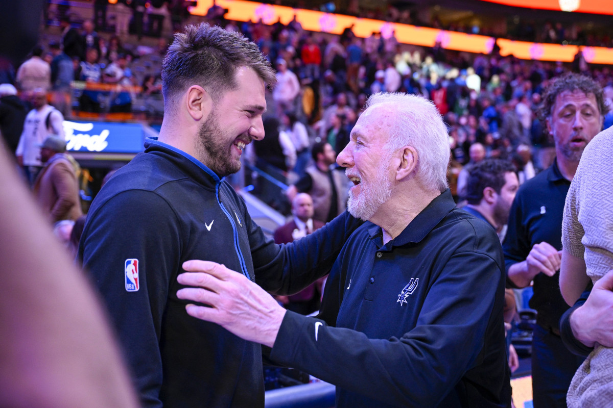 Dallas Mavericks’ Luka Doncic and San Antonio Spurs coach Gregg Popovich embrace during the 2022-23 season.