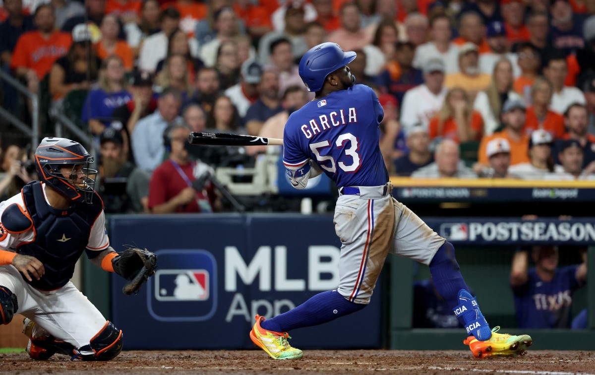 Texas Rangers right fielder Adolis Garcia hits a two-RBI single