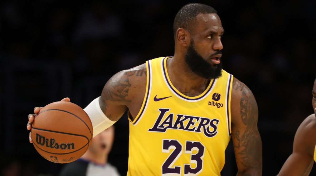 Lakers forward LeBron James dribbles the ball during a preseason game.