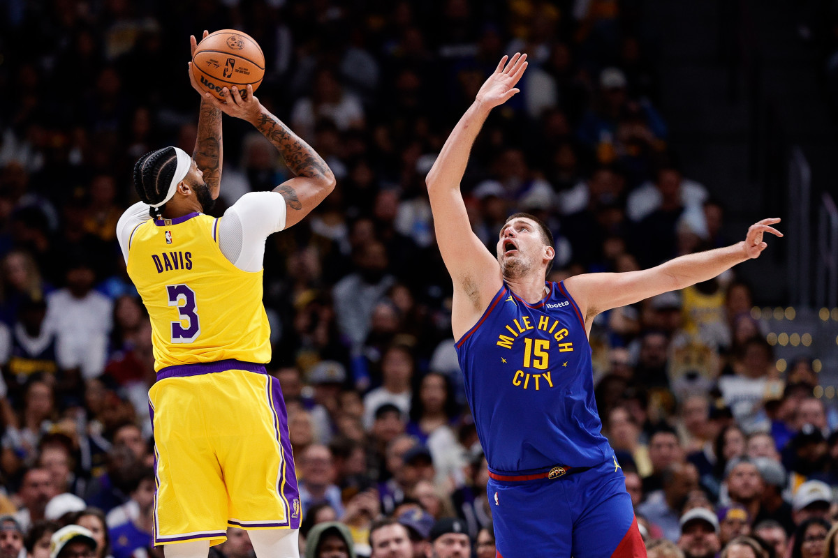 Los Angeles Lakers forward Anthony Davis attempts a shot as Denver Nuggets center Nikola Jokic.