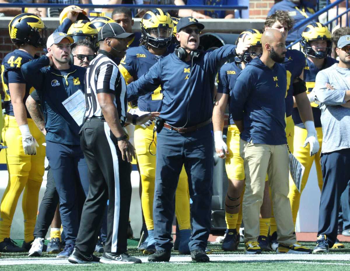 Connor Stalions standing on the Michigan football sideline.