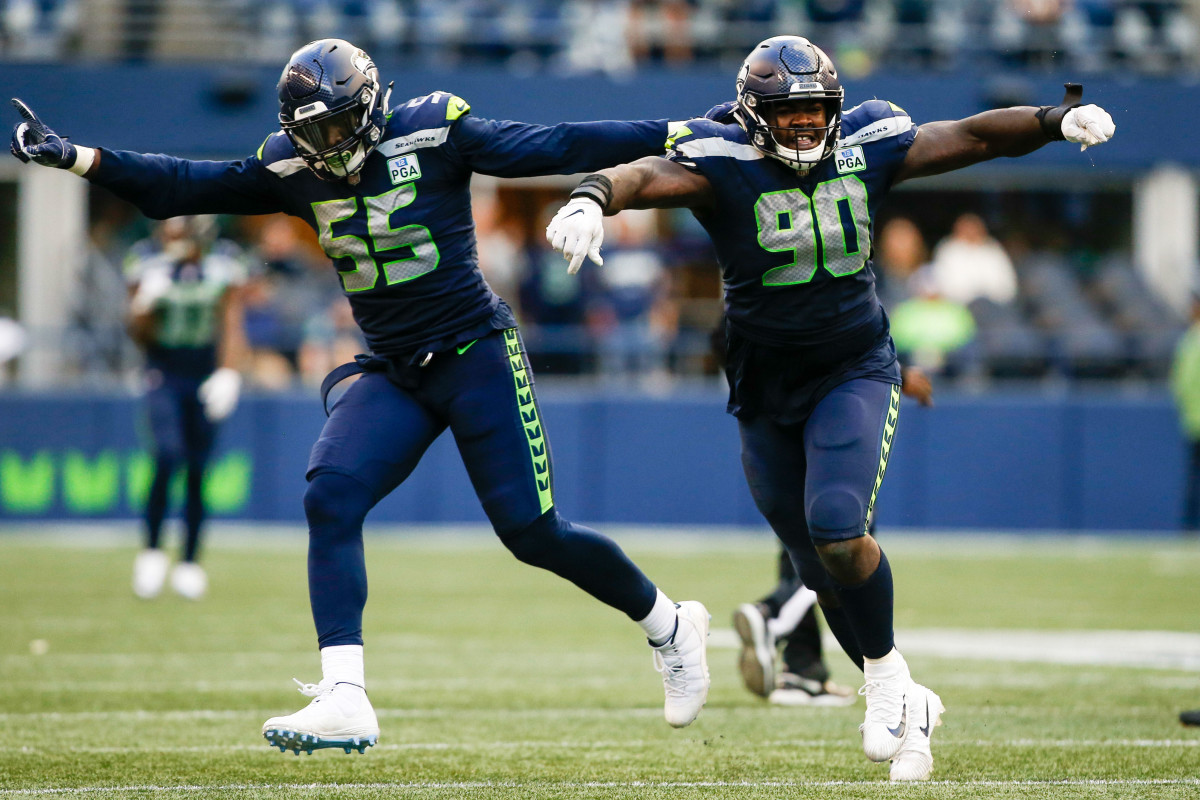Seattle Seahawks defensive tackle Jarran Reed (90) celebrates with defensive end Frank Clark (55) following a sack against the Los Angeles Chargers during the fourth quarter at CenturyLink Field.