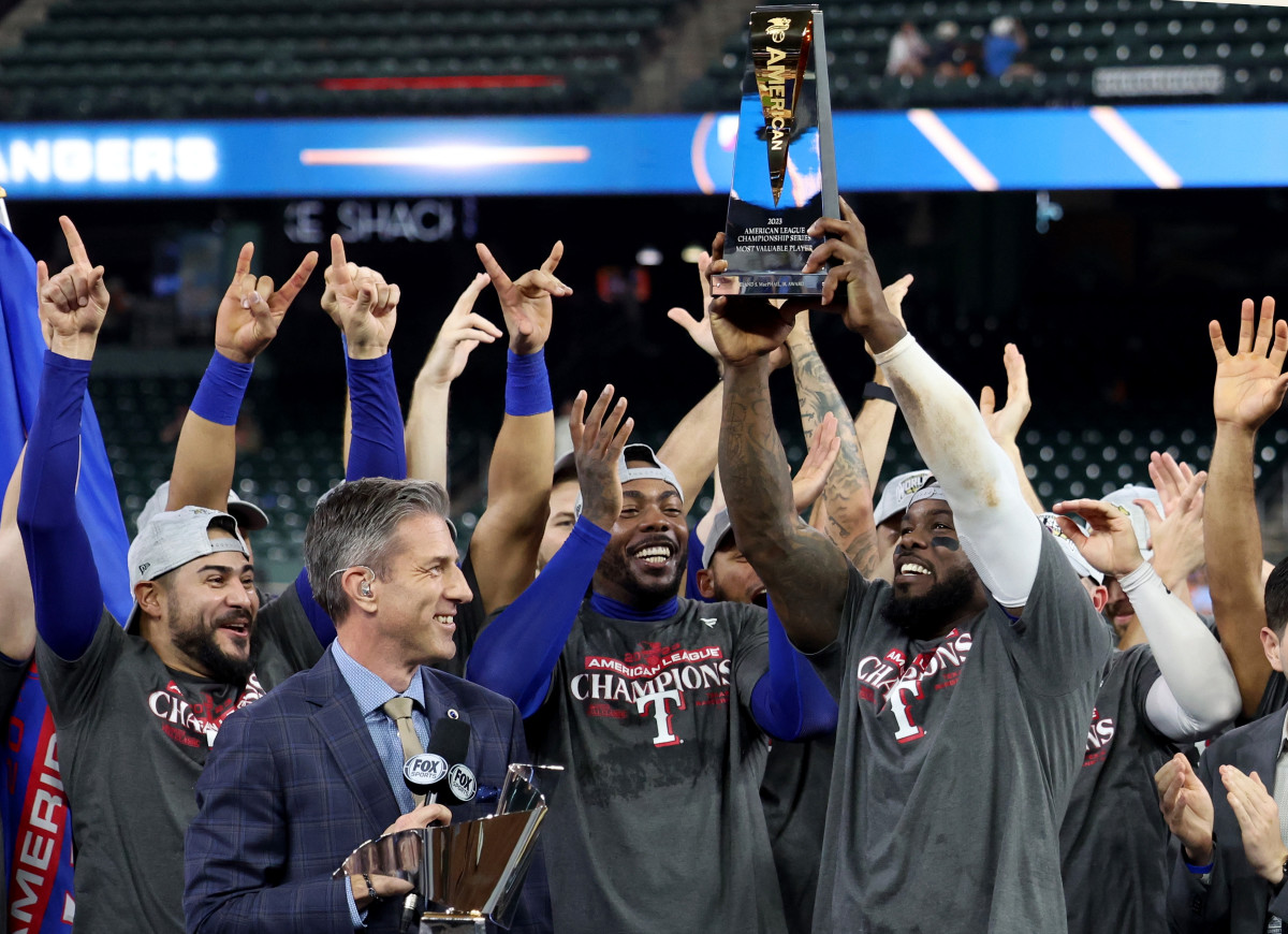 Oct 23, 2023; Houston, Texas, USA; Texas Rangers right fielder Adolis Garcia (53) holds the American League championship series MVP trophy after winning game seven in the ALCS against the Houston Astros for the 2023 MLB playoffs at Minute Maid Park. Mandatory Credit: Thomas Shea-USA TODAY Sports