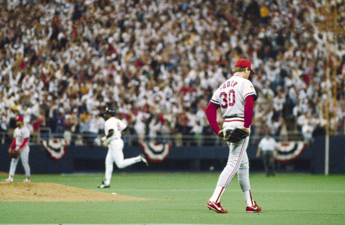 Cardinals pitcher John Tudor walks around the mound as a Twins player rounds the bases during the 1987 World Series