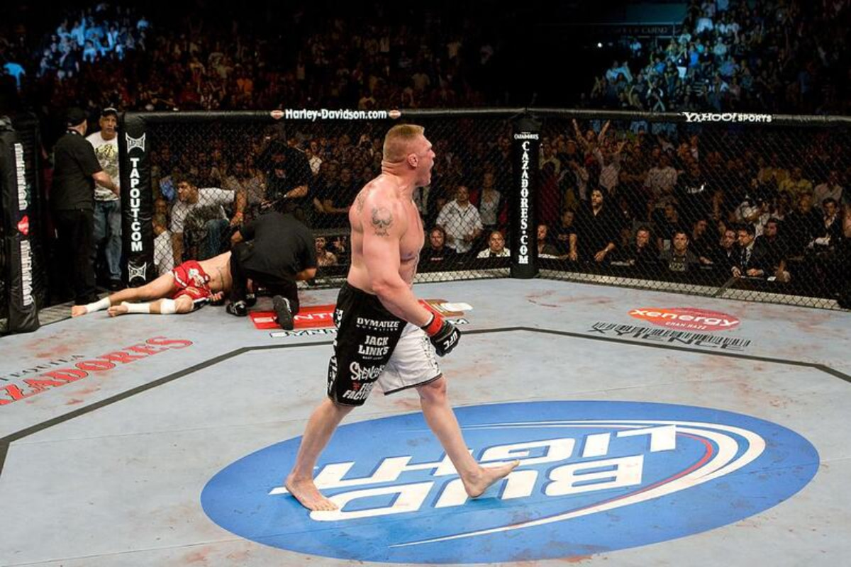 Brock Lesnar celebrates his UFC 100 victory over Frank Mir while on the center Bud Light logo.