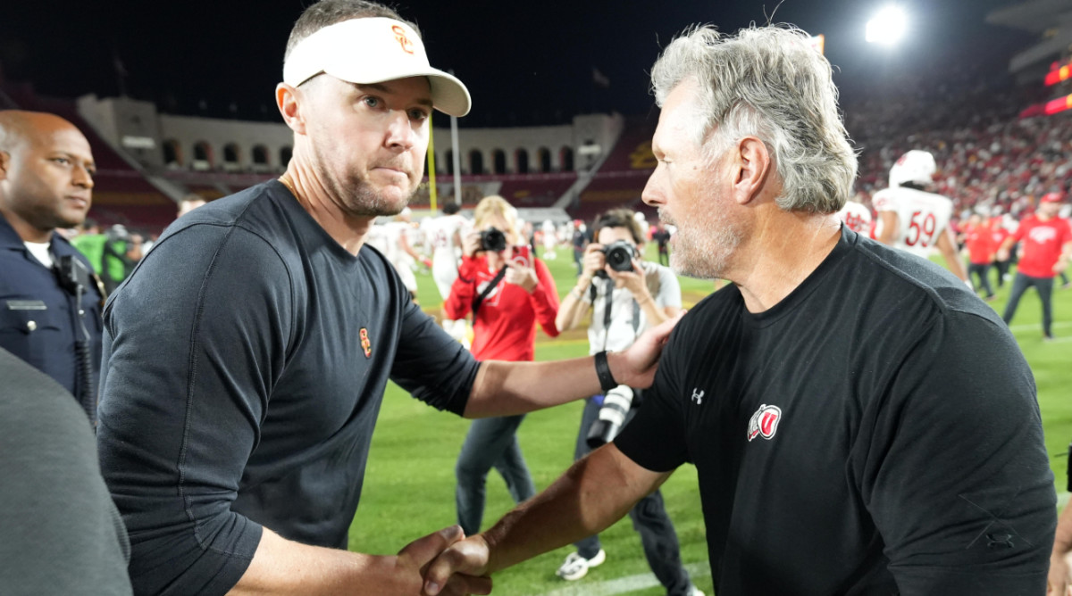 USC coach Lincoln Riley and Utah’s Kyle Whittingham meet at midfield following a 34–32 win for the Utes in Los Angeles.
