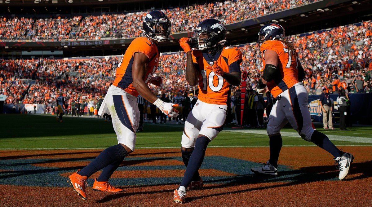 Broncos wide receiver Courtland Sutton and Jerry Jeudy celebrate after scoring a touchdown.