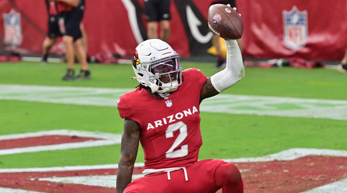 Cardinals wide receiver Marquise Brown holds the ball up after catching a touchdown.