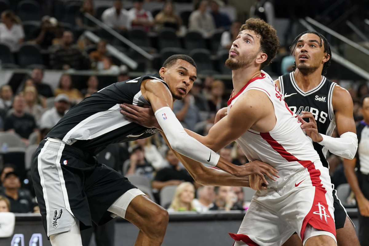 Spurs forward Victor Wembanyama and Houston Rockets center Alperen Sengun (28) battle for the rebound during the first half at Frost Bank Center.