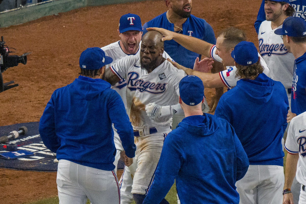 Oct 27, 2023; Arlington, Texas, USA; Texas Rangers starting pitcher Max Scherzer (31) and first baseman Nathaniel Lowe (30) celebrate after right fielder Adolis Garcia (53) hits a walk-off home run to defeat the Arizona Diamondbacks during the eleventh inning in game one of the 2023 World Series at Globe Life Field. Mandatory Credit: Jerome Miron-USA TODAY Sports