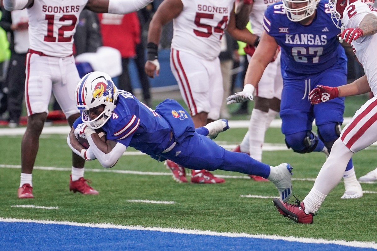 Oct 28, 2023; Lawrence, Kansas, USA; Kansas Jayhawks running back Devin Neal (4) scores the final touchdown against the Oklahoma Sooners during the second half at David Booth Kansas Memorial Stadium.