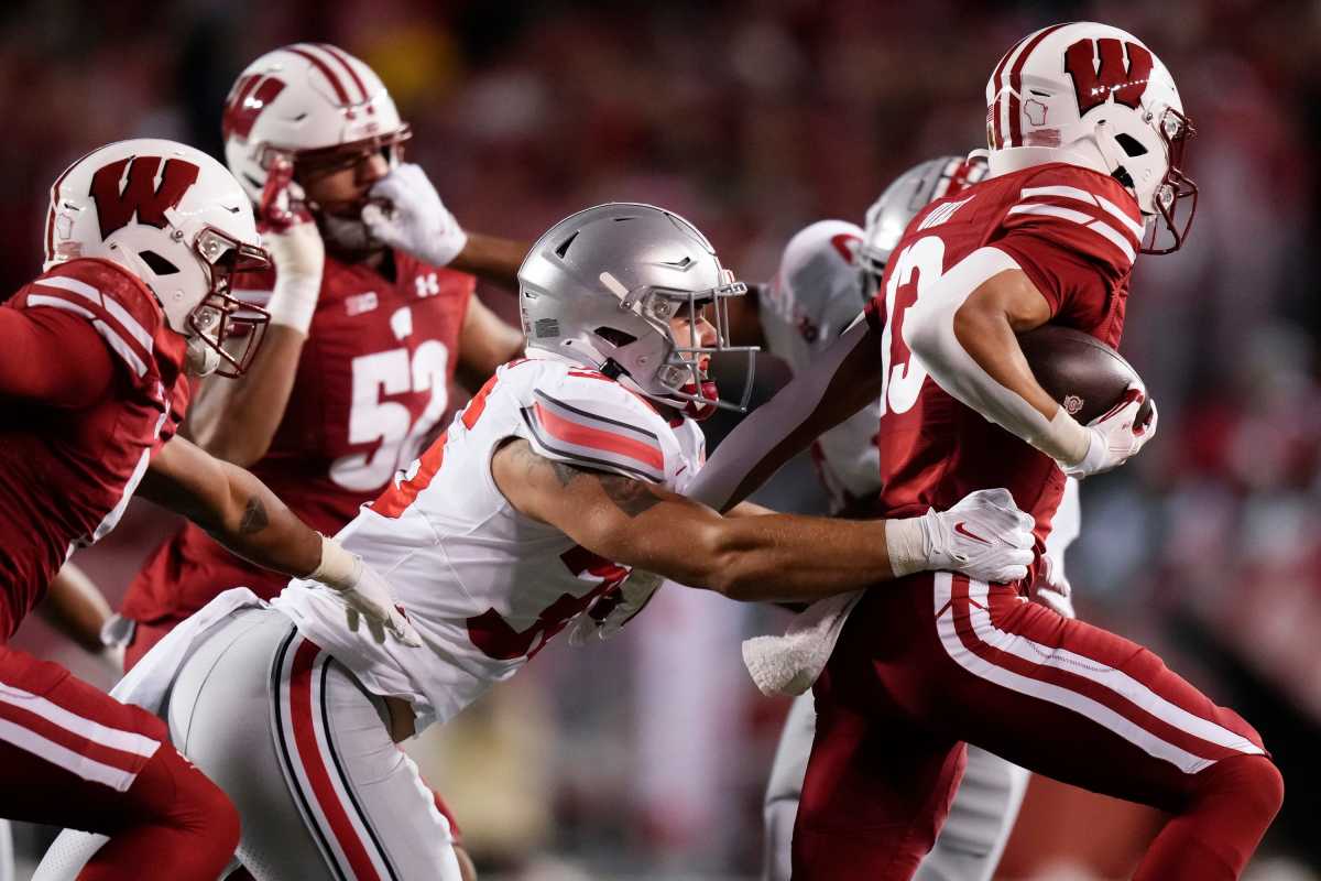 Oct 28, 2023; Madison, Wisconsin, USA; Ohio State Buckeyes linebacker Gabe Powers (36) tackles Wisconsin Badgers wide receiver Chimere Dike (13) during the NCAA football game at Camp Randall Stadium. Ohio State won 24-10.