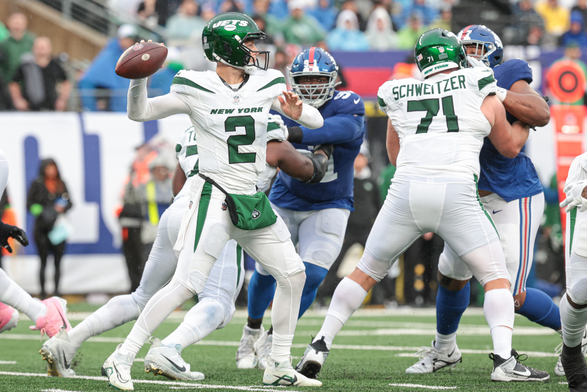 New York Jets quarterback Zach Wilson throws the ball as New York Giants defensive tackle A'Shawn Robinson pursues during the first half at MetLife Stadium.
