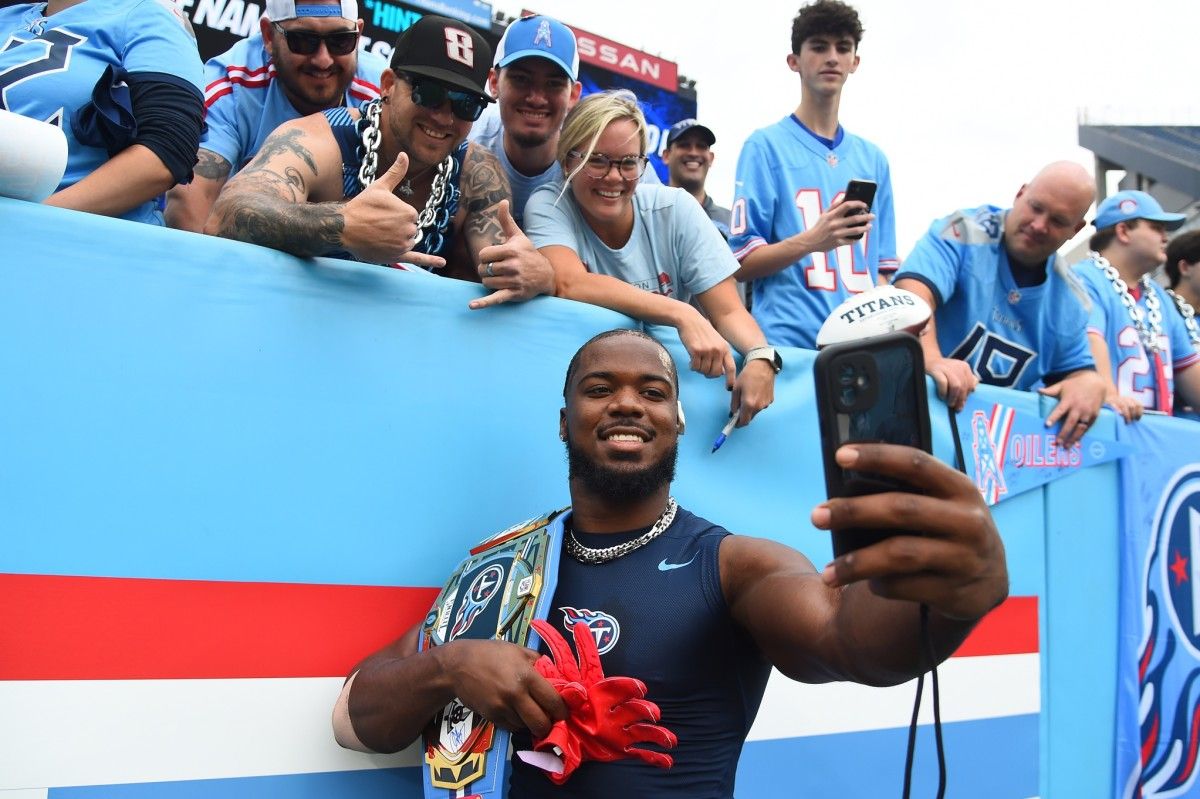Tennessee Titans linebacker Azeez Al-Shaair (2) takes a selfie with fans before the game against the Atlanta Falcons at Nissan Stadium.