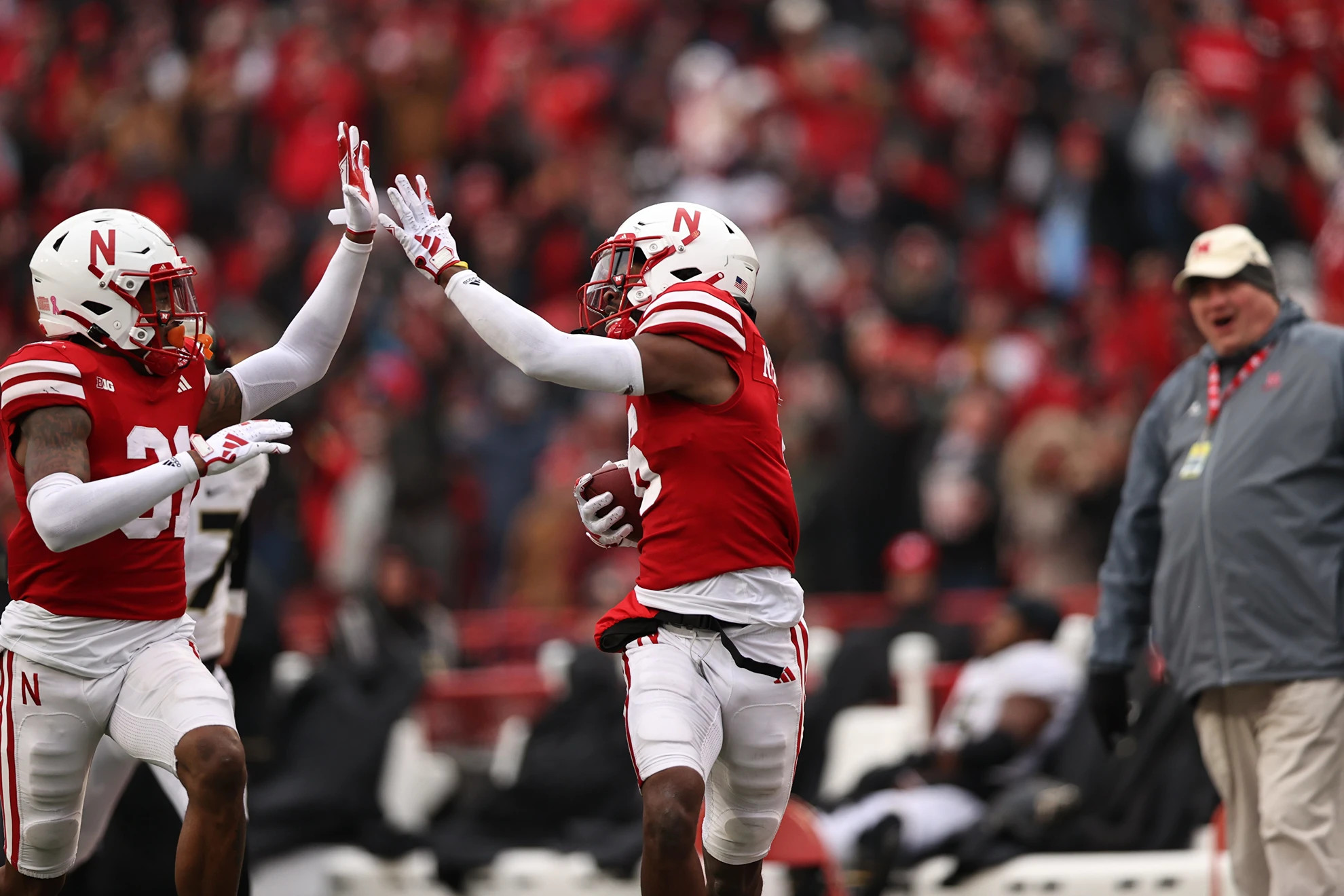 Nebraska defensive backs Tommi Hill (left) and Quinton Newsome (right) high five during a return against Purdue (Oct. 28, 2023)