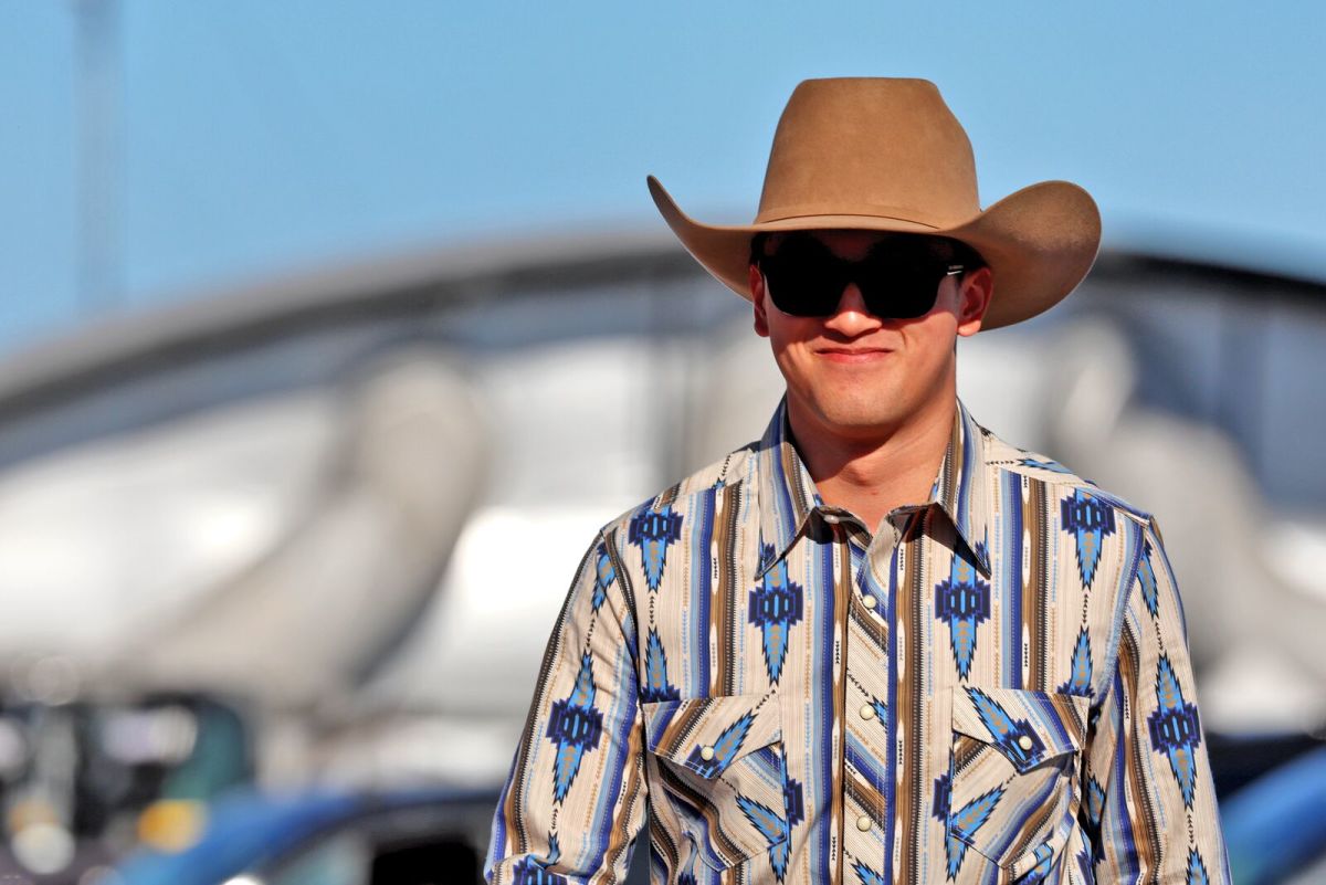 Zhou Guanyu wears sunglasses and a cowboy hat while in the paddock for the U.S. Grand Prix in Austin