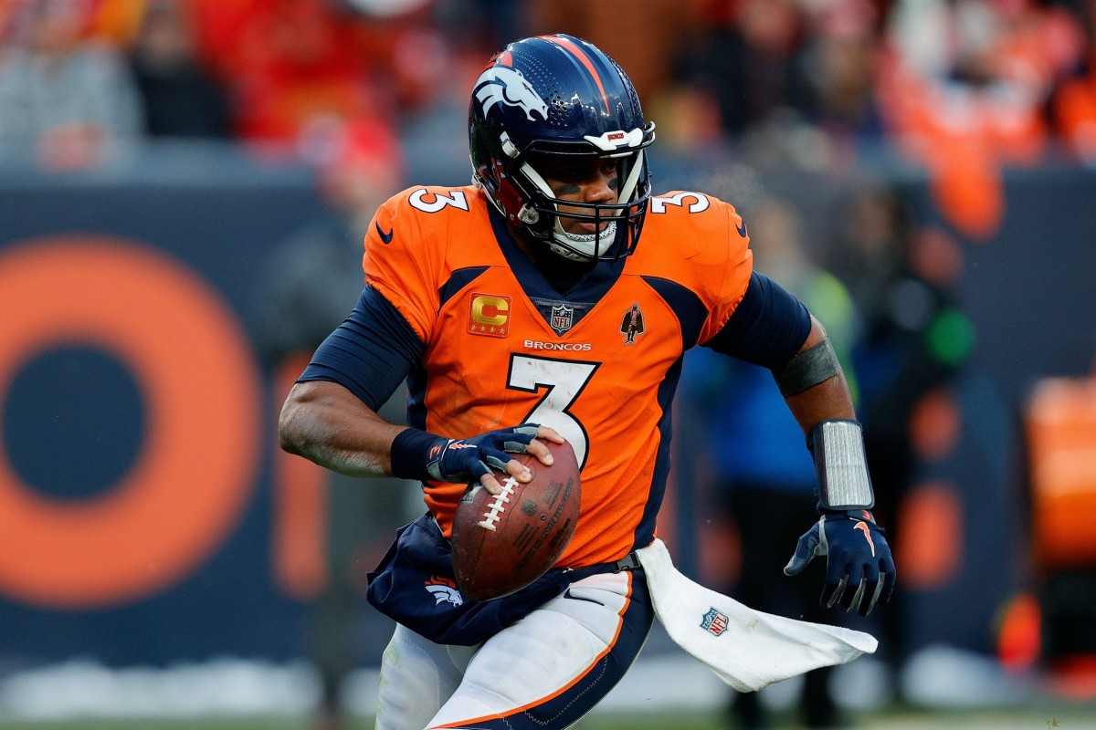 Denver Broncos quarterback Russell Wilson (3) scrambles in the fourth quarter against the Kansas City Chiefs at Empower Field at Mile High.