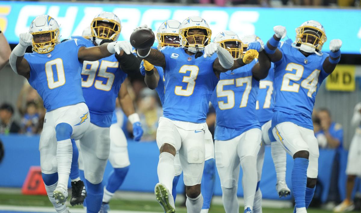 Los Angeles Chargers safety Derwin James Jr. (3) celebrates with linebacker Daiyan Henley (0) and safety AJ Finley (24) after intercepting a pass against the Chicago Bears in the second half at SoFi Stadium.