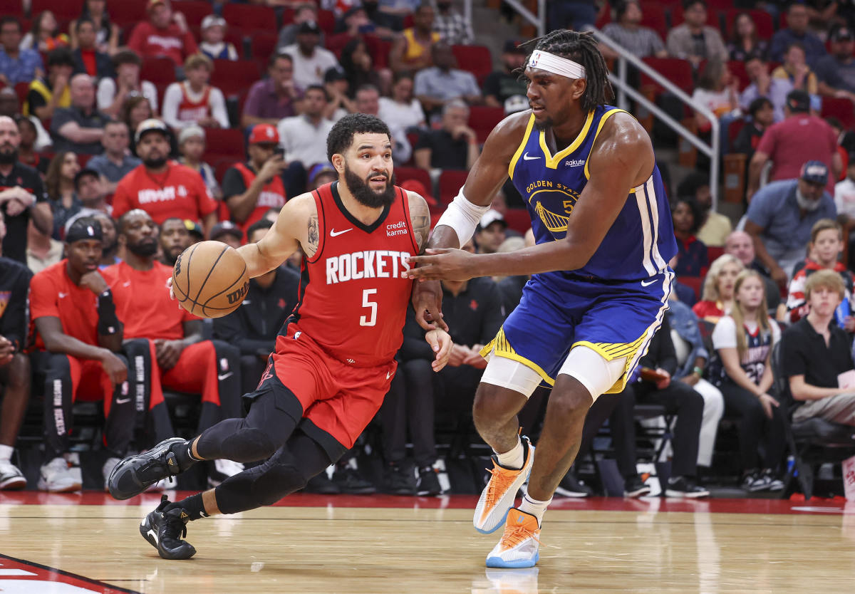 Houston Rockets guard Fred VanVleet (5) dribbles the ball as Golden State Warriors forward Kevon Looney (5) defends during the game at Toyota Center.