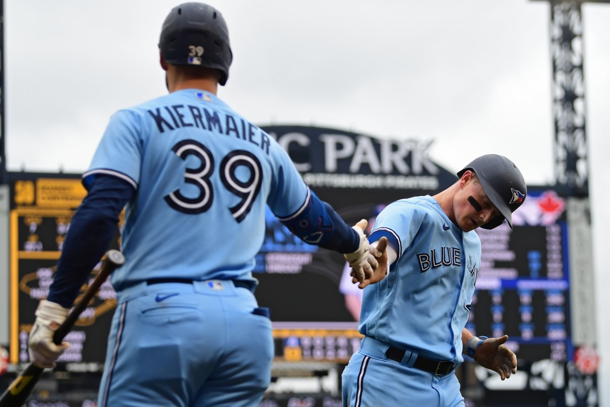 Toronto Blue Jays third baseman Matt Chapman (26) is congratulated by center fielder Kevin Kiermaier (39) after scoring a run during the fifth inning against the Pittsburgh Pirates at PNC Park.