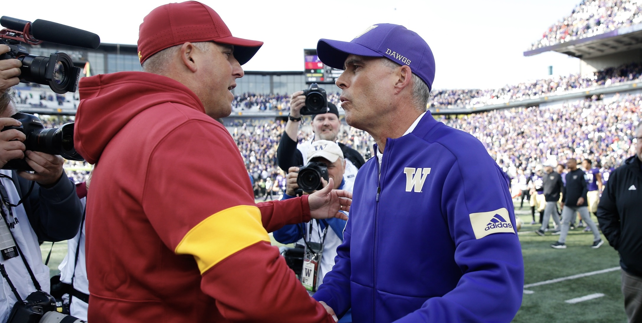 Clay Helton and Chris Petersen, both out of the Pac-12 now, greet each other after the 2019 game, which the UW won 28-14.
