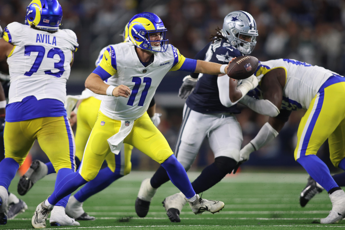 Oct 29, 2023; Arlington, Texas, USA; Los Angeles Rams quarterback Brett Rypien (11) pitches the ball in the third quarter against the Dallas Cowboys at AT&T Stadium. Mandatory Credit: Tim Heitman-USA TODAY Sports