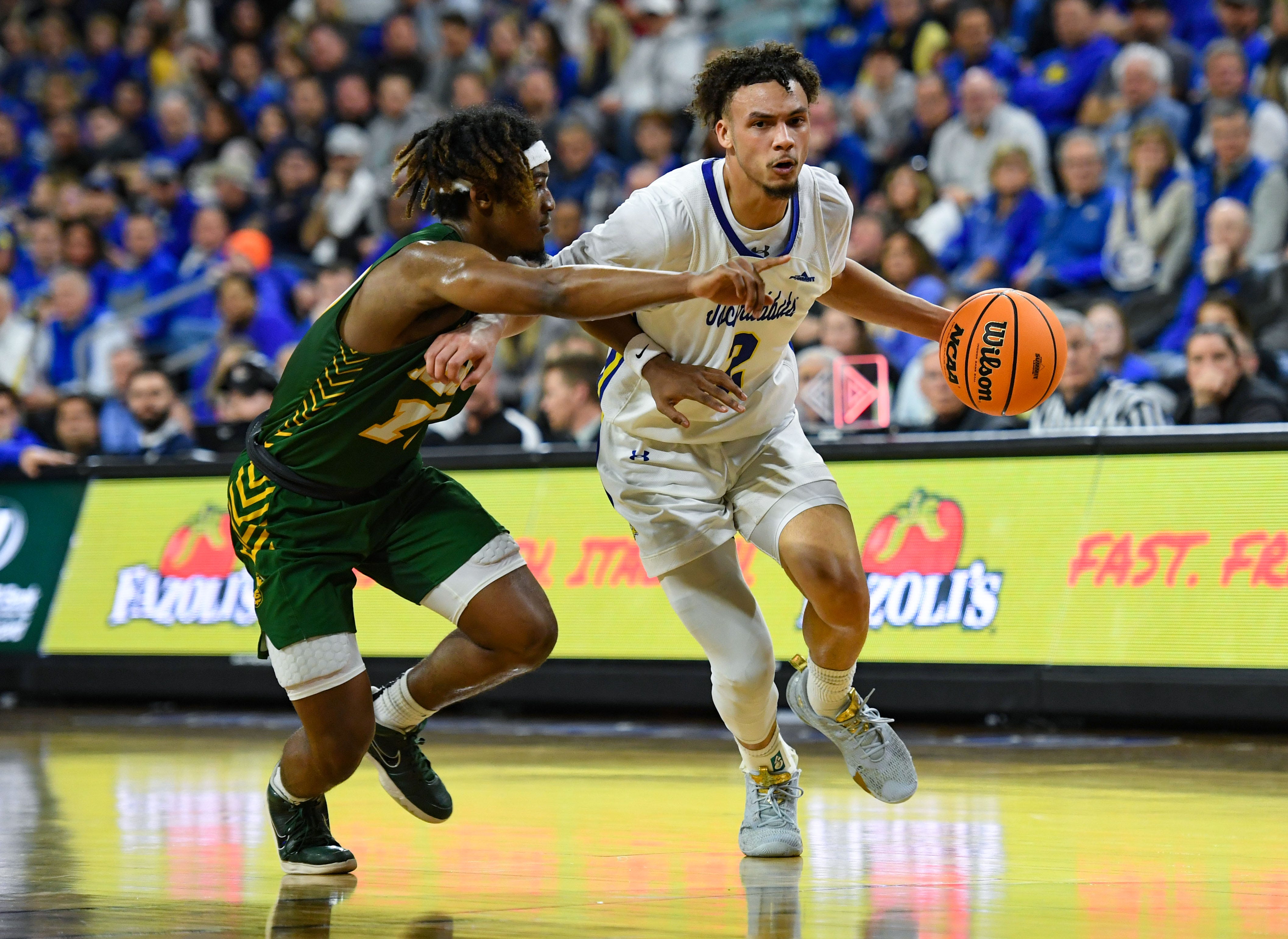 South Dakota State's Zeke Mayo dribbles toward the basket, guarded by North Dakota State's Damari Wheeler-Thomas in the Summit League men's semifinals on Monday, March 6, 2023, at the Denny Sanford Premier Center in Sioux Falls.