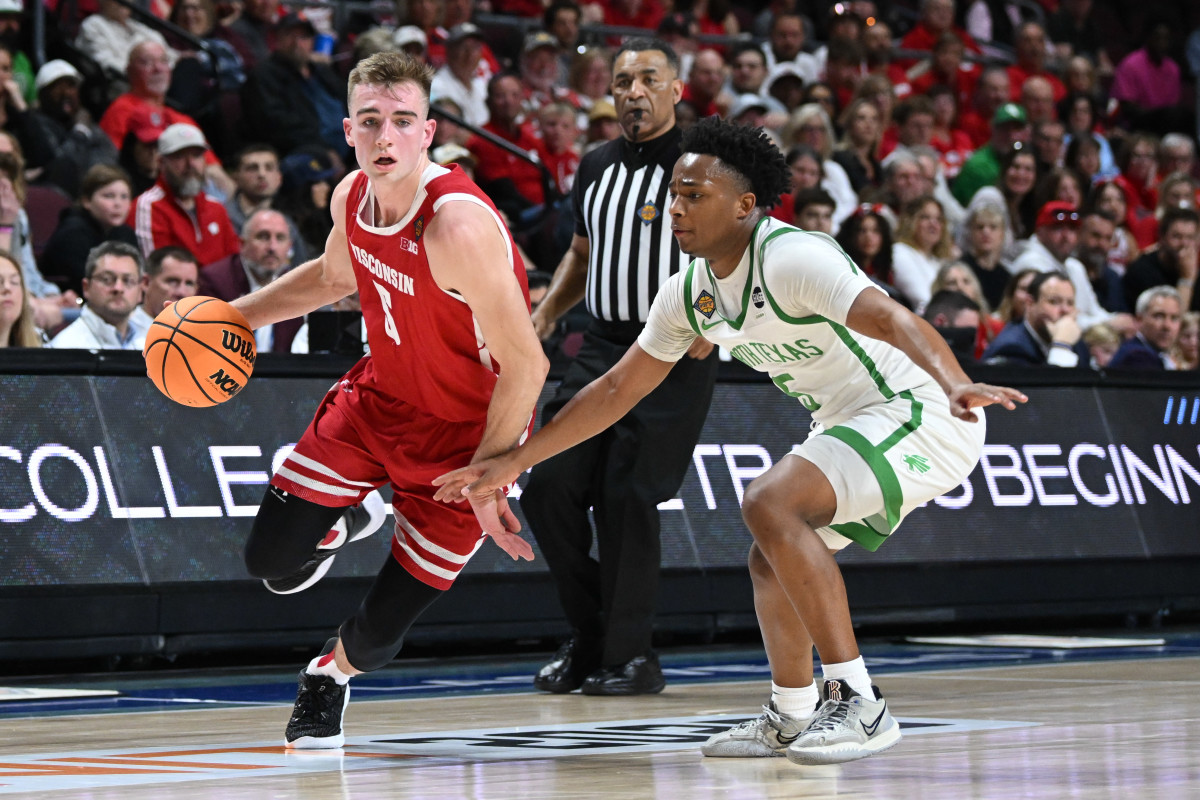 Mar 28, 2023; Las Vegas, NV, USA; Wisconsin Badgers forward Tyler Wahl (5) dribbles past North Texas Mean Green guard Tylor Perry (5) during the first half at Orleans Arena. Mandatory Credit: Candice Ward-USA TODAY Sports