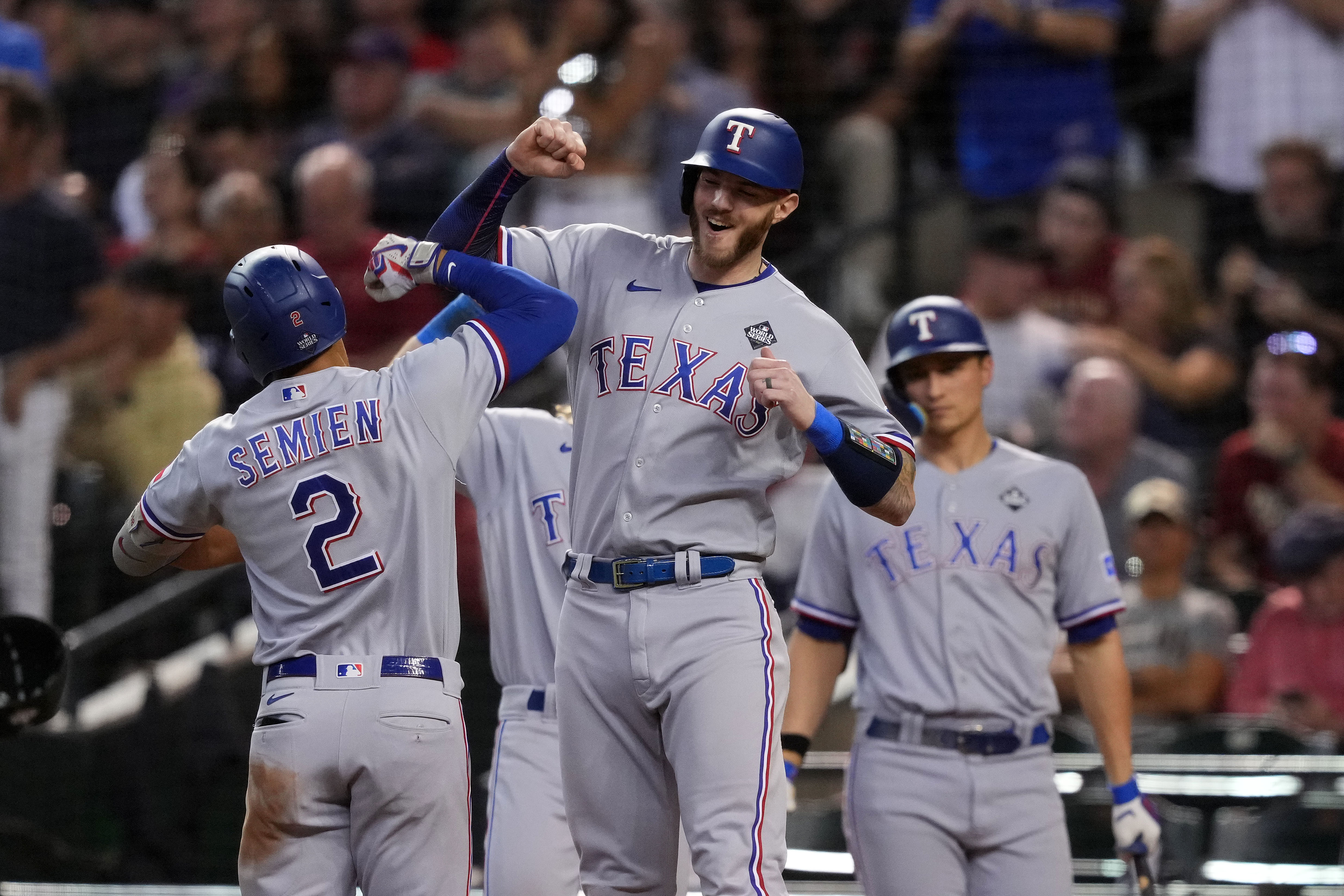 Marcus Semien celebrates his three-run home run with teammates in the third inning of the Texas Rangers' 11-7 Game 4 World Series win over the Arizona Diamondbacks Tuesday at Chase Field in Phoenix.
